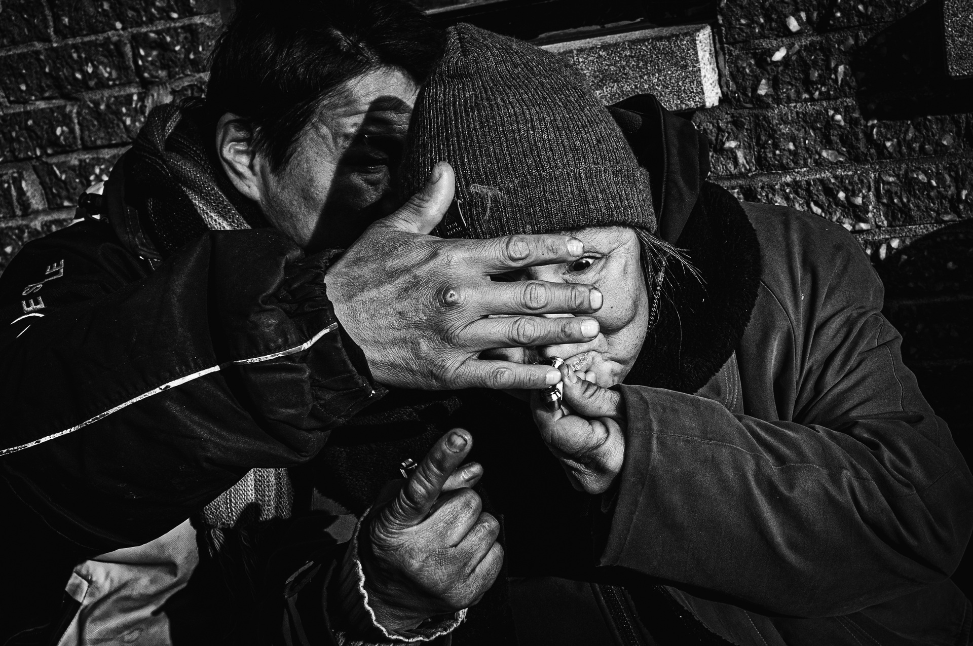 Bob shields Mary's face with his hand as she lights a cigarette — Looking for Mary